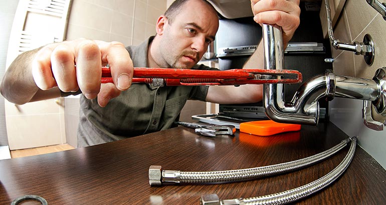 Commercial plumber fixing a pipe